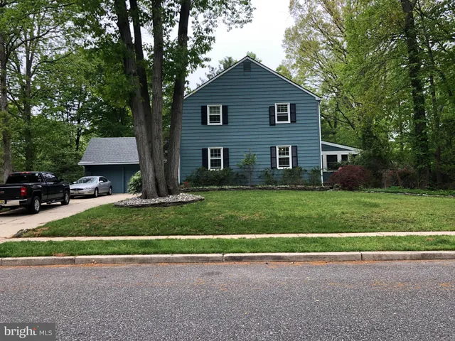 a front view of a house with a yard and a garage