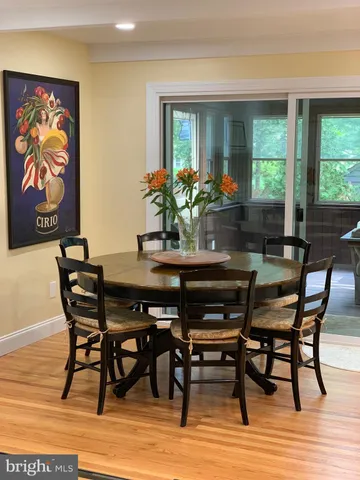 a dining room with furniture a rug and wooden floor