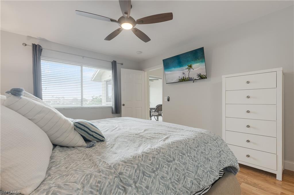 7766 Emerald Circle, Unit R203 Naples, FL 34109 - Photo 18 of 30 Bedroom with light wood-type flooring and a ceiling fan