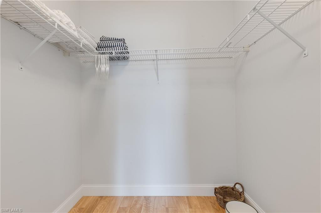7766 Emerald Circle, Unit R203 Naples, FL 34109 - Photo 20 of 30 Walk in closet with light wood-style floors