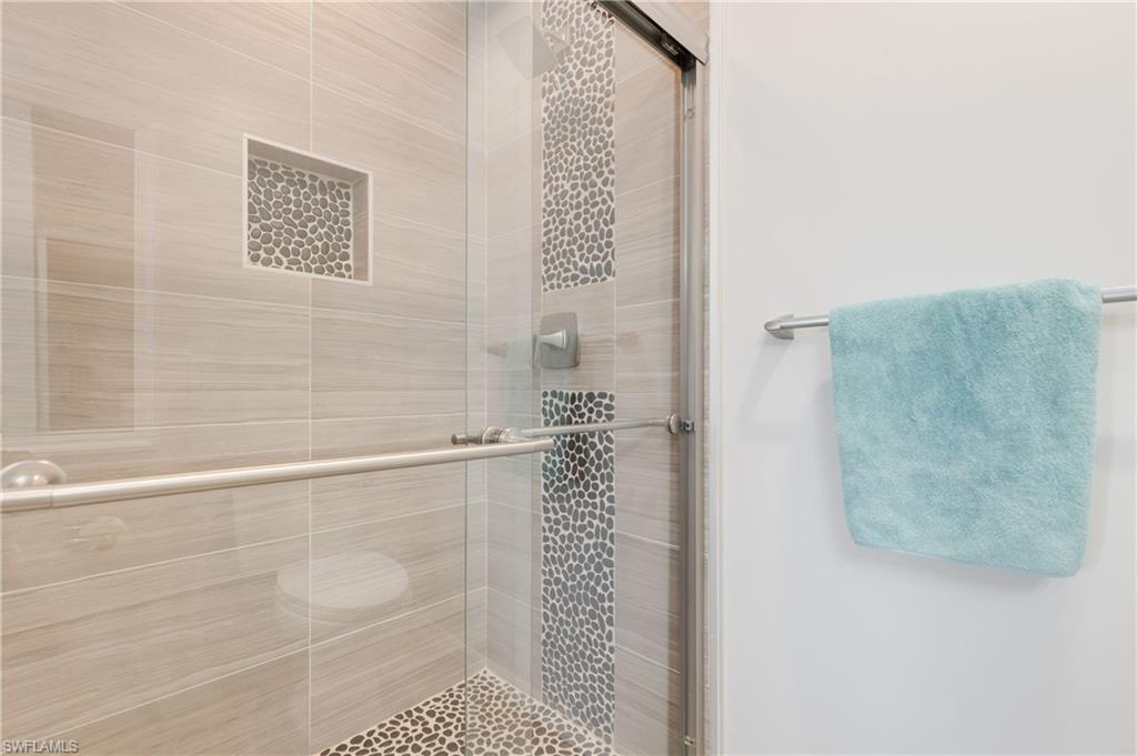 7766 Emerald Circle, Unit R203 Naples, FL 34109 - Photo 22 of 30 Bathroom featuring a stall shower