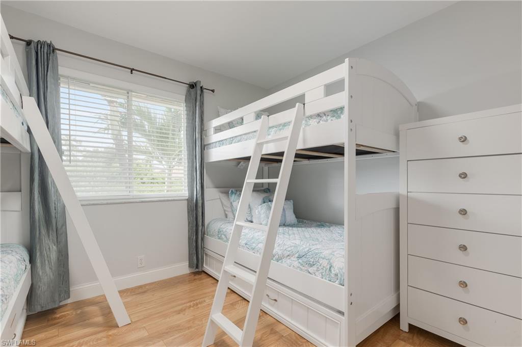 7766 Emerald Circle, Unit R203 Naples, FL 34109 - Photo 24 of 30 Unfurnished bedroom with light wood-style flooring and baseboards