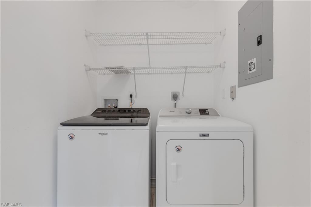 7766 Emerald Circle, Unit R203 Naples, FL 34109 - Photo 26 of 30 Laundry area featuring washer and dryer and electric panel