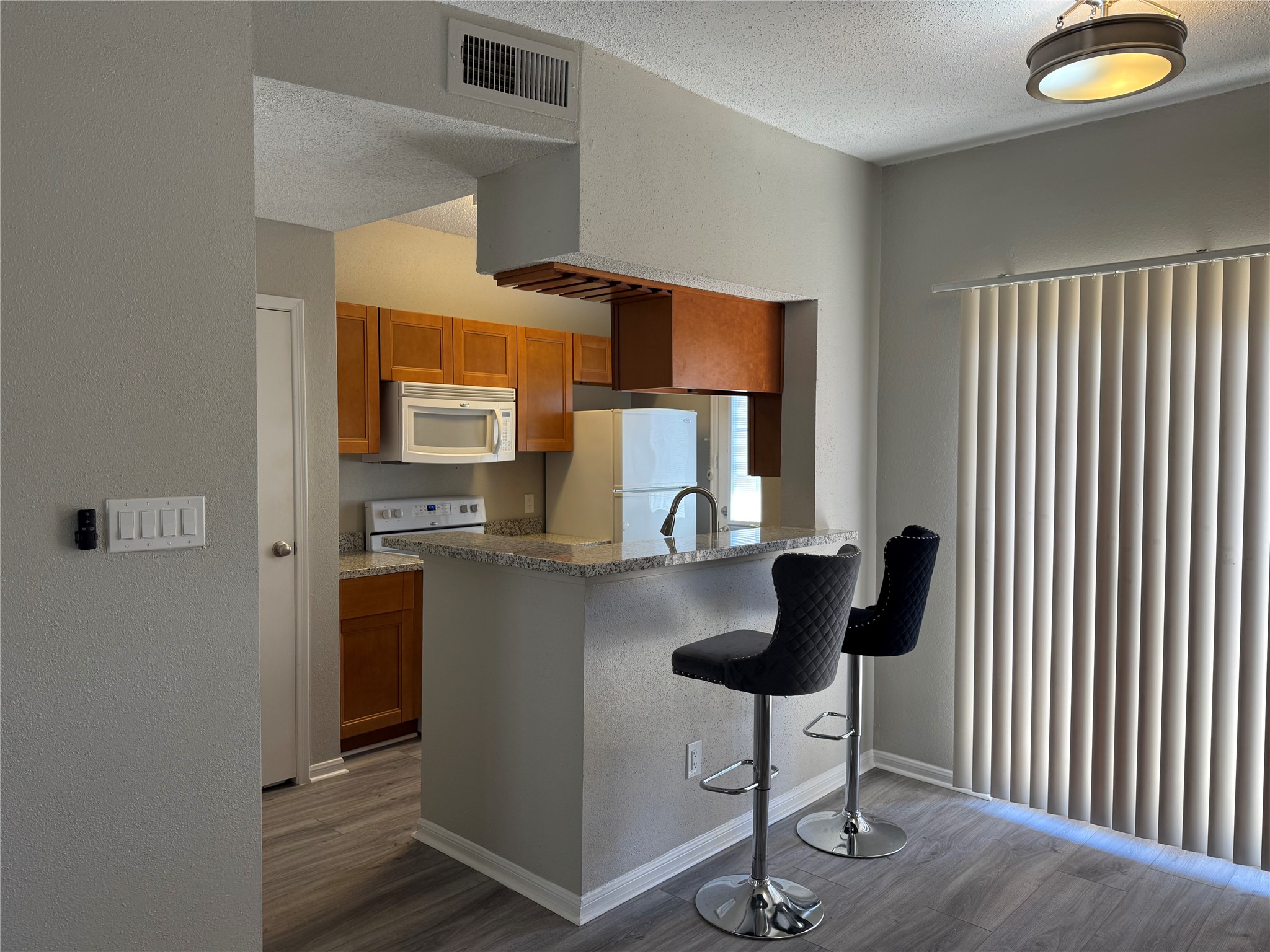7575 Cambridge Street, Unit 2804 Houston, TX 77054 - Photo 15 of 38 a kitchen with stainless steel appliances granite countertop a refrigerator and a stove top oven