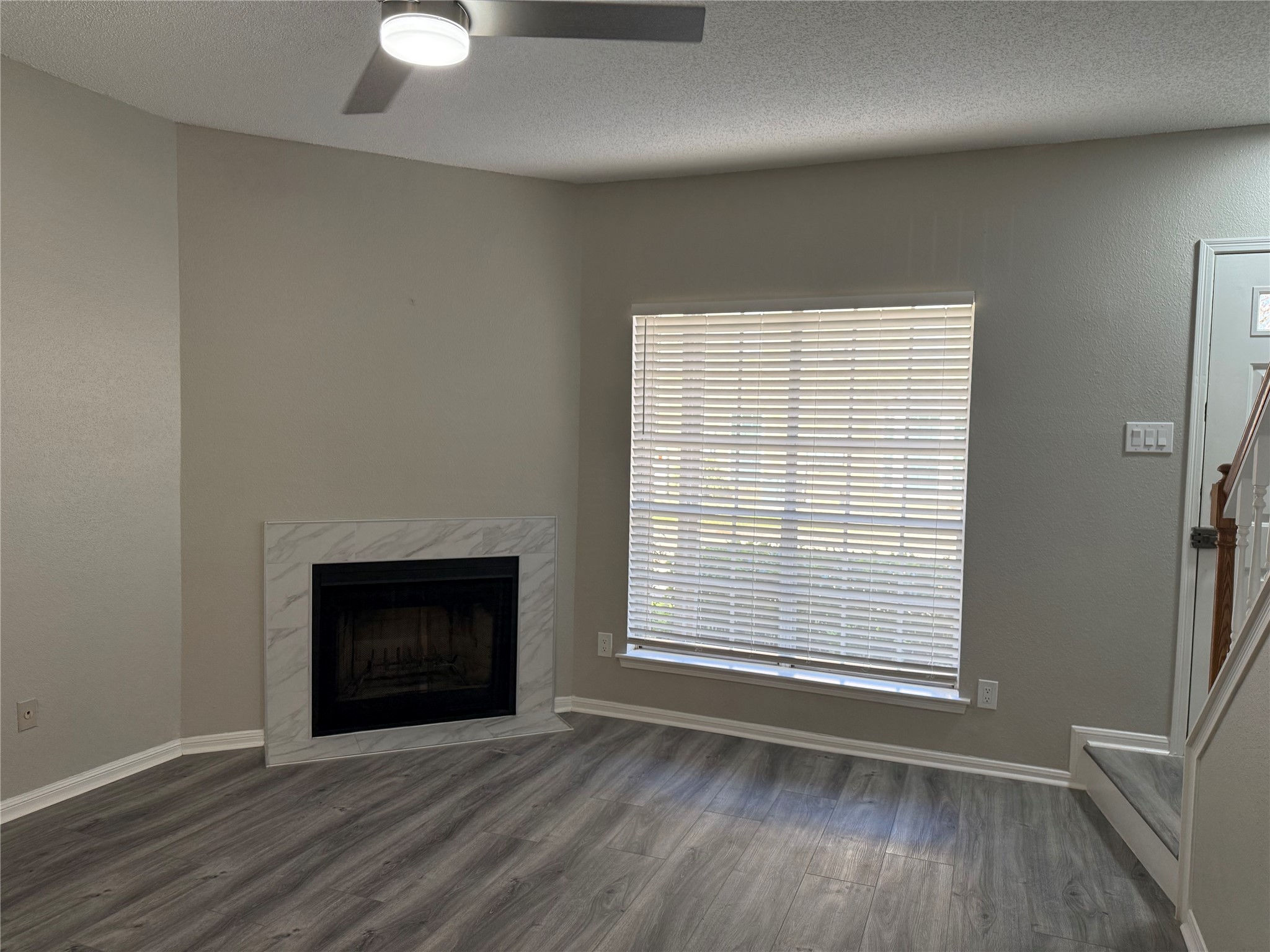 7575 Cambridge Street, Unit 2804 Houston, TX 77054 - Photo 2 of 38 an empty room with wooden floor fireplace and windows