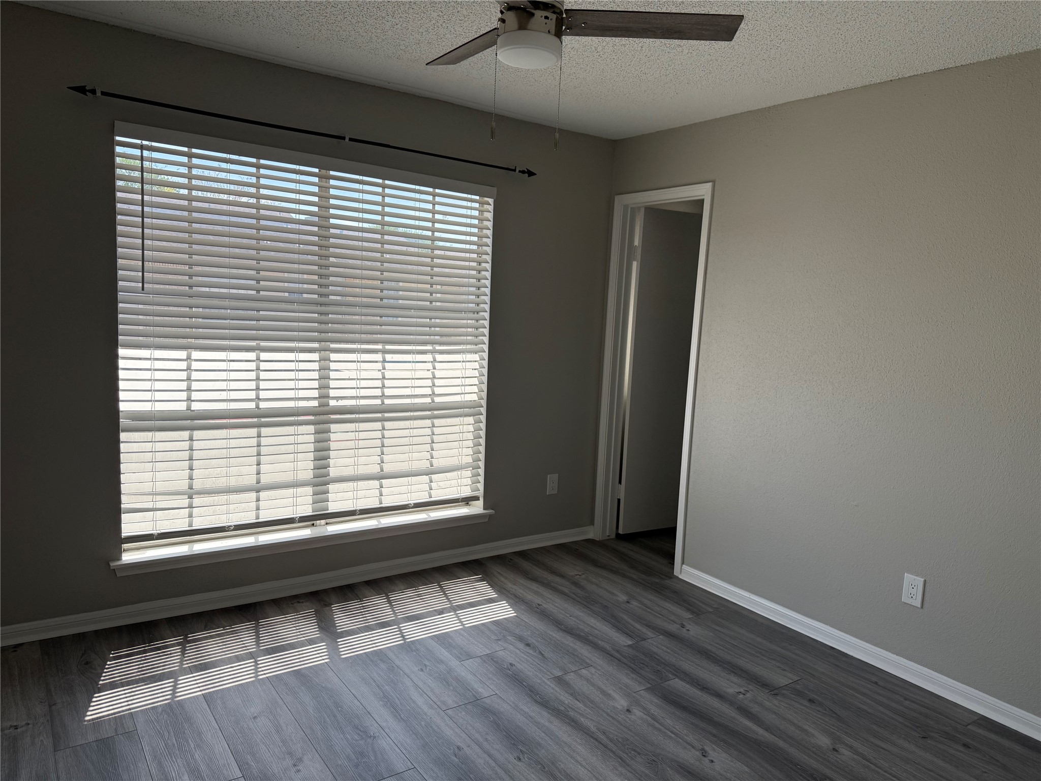 7575 Cambridge Street, Unit 2804 Houston, TX 77054 - Photo 27 of 38 a view of an empty room with wooden floor and a window