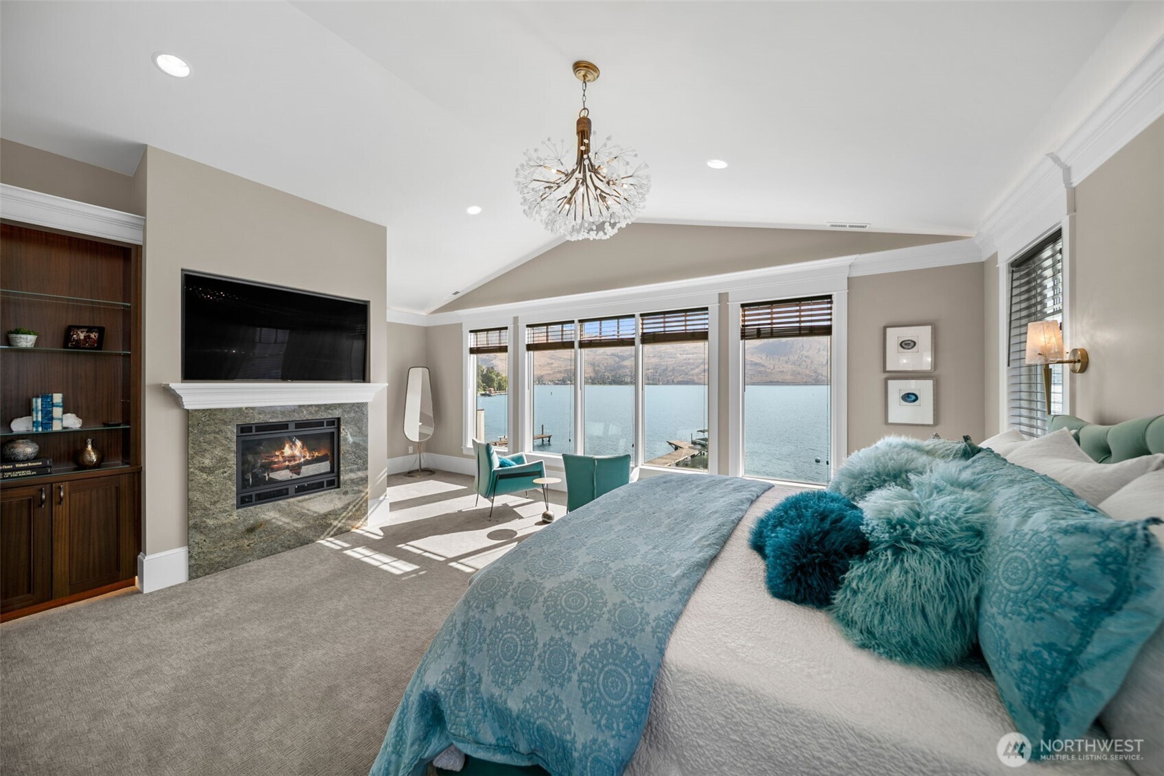 58 Key Bay Lane Chelan, WA 98816 - Photo 26 of 40 a spacious bedroom with a bed and a fireplace
