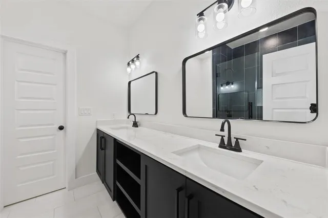 a bathroom with a double vanity sink and mirror