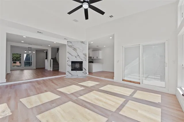 a view of an empty room with a fireplace and a window