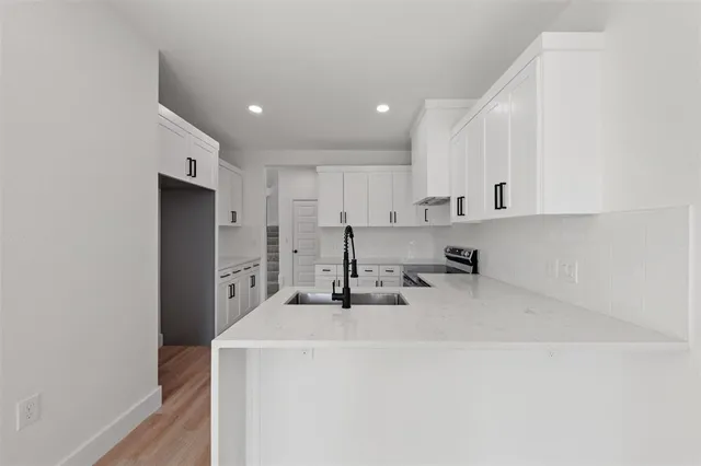 a kitchen with a sink a stove and a refrigerator