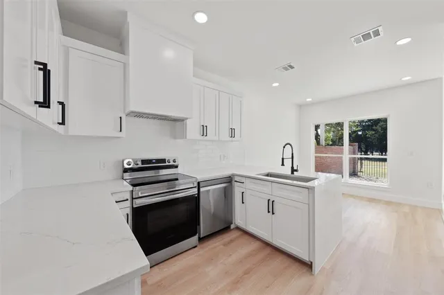 a kitchen with a stove and a sink