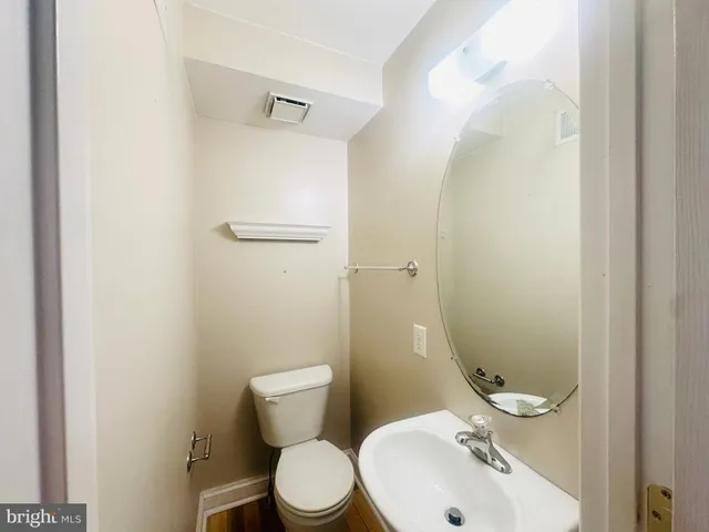 a white toilet sitting next to a bathroom sink