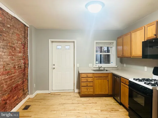 a kitchen with stainless steel appliances granite countertop a stove sink and cabinets