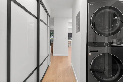 a view of a hallway with washer and dryer