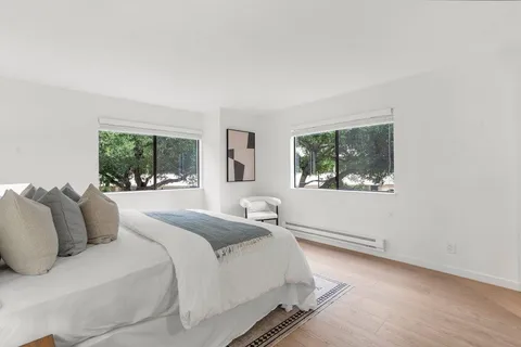 a bedroom with a large bed and a window