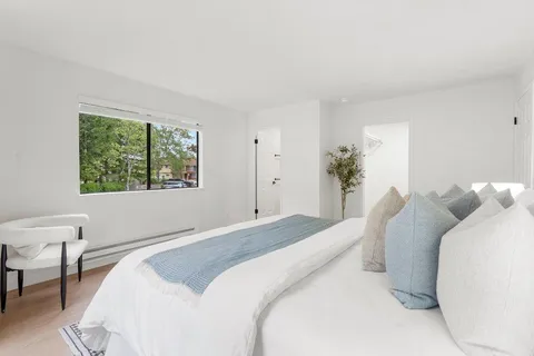 a bedroom with a bed and a window