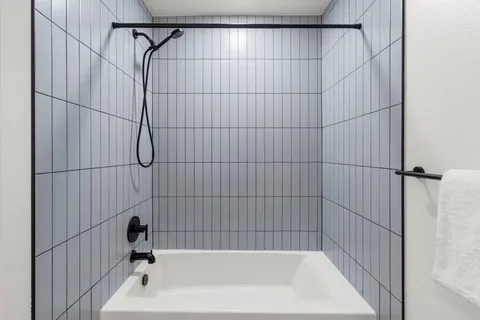 a bathroom with a bathtub and shower