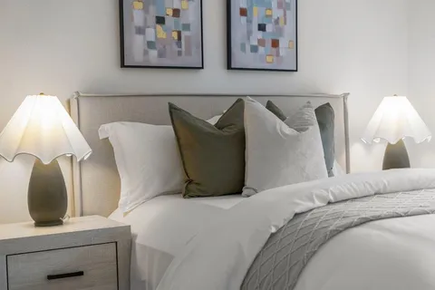 a bedroom with a bed and lamp
