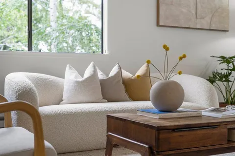 a living room with furniture and potted plant