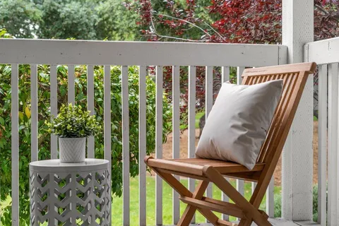 a view of balcony with furniture and garden