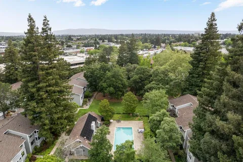 an aerial view of a city with lots of residential buildings lake and ocean view