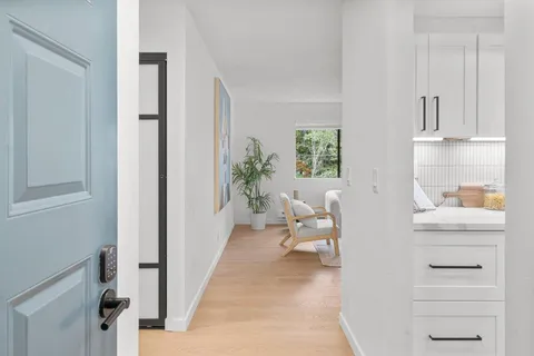 a living room with furniture a rug and a window