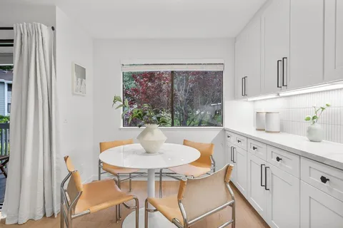 a kitchen with a table and chairs in it