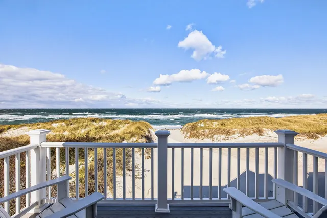 a front view of a house with a yard table and chairs
