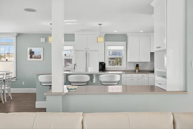 a kitchen with stainless steel appliances kitchen island a refrigerator and a sink