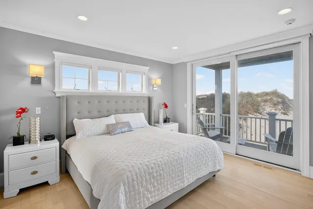 a bedroom with a large bed and a potted plant