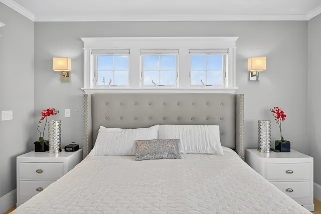 a spacious bedroom with a large bed and a large window