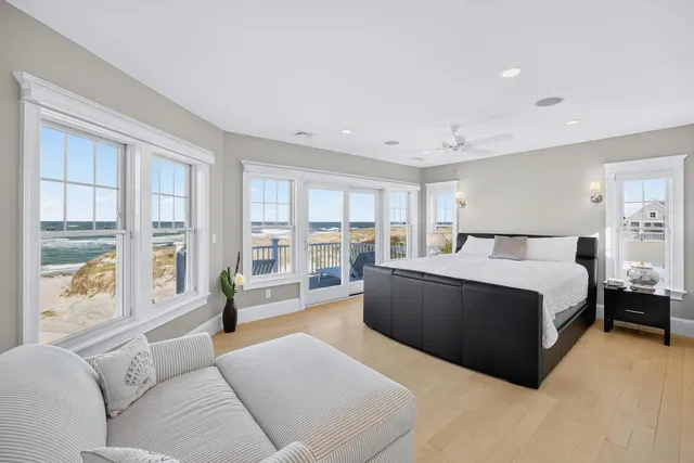 a bedroom with two large bed and a large window