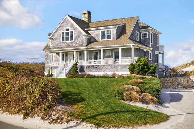 a front view of a house with a yard table and chairs