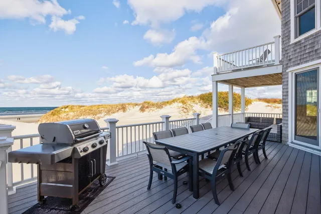 a view of a roof deck with table and chairs