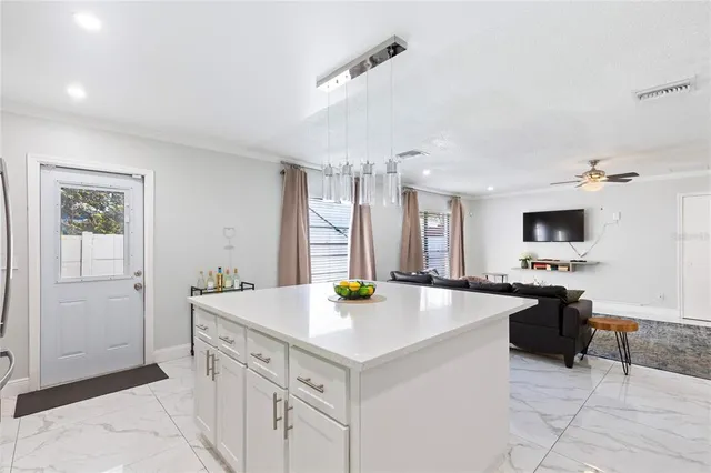 a kitchen with sink and refrigerator