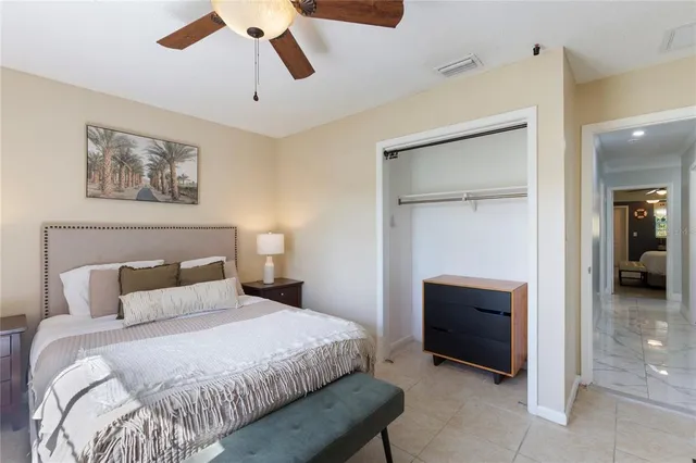 a bedroom with a bed and a ceiling fan