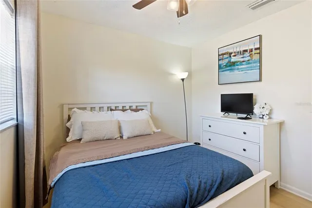 a bedroom with a bed and flat screen tv