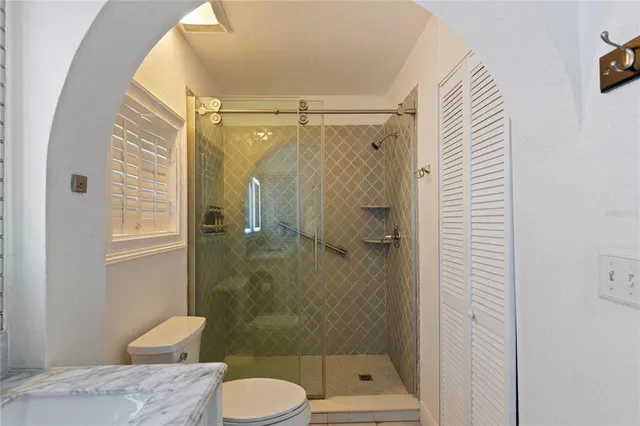 a bathroom with a toilet and a shower