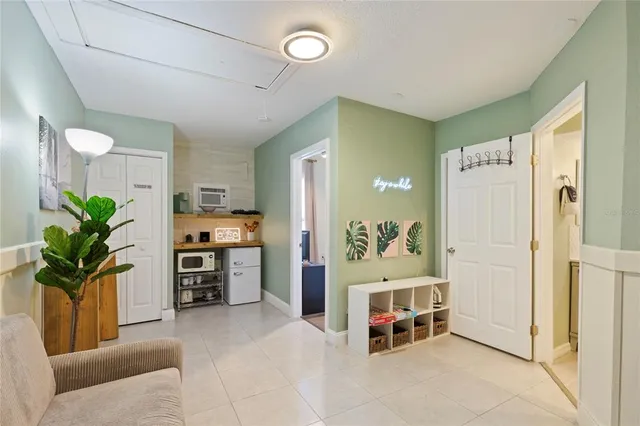 a living room with furniture and a potted plant