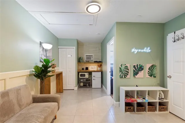 a living room with furniture potted plant and a chandelier