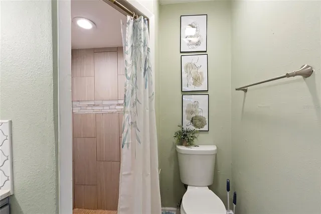 a white toilet sitting next to a bathroom sink