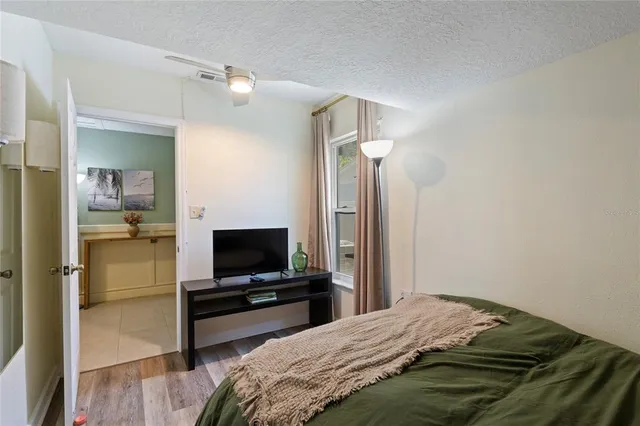 a bedroom with a bed and a flat screen tv