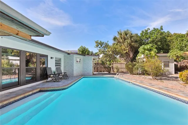 a view of a patio with table and chairs and potted plants