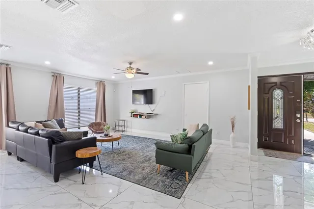 a living room with furniture and wooden floor