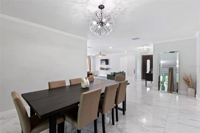 a dining room with a table and chairs