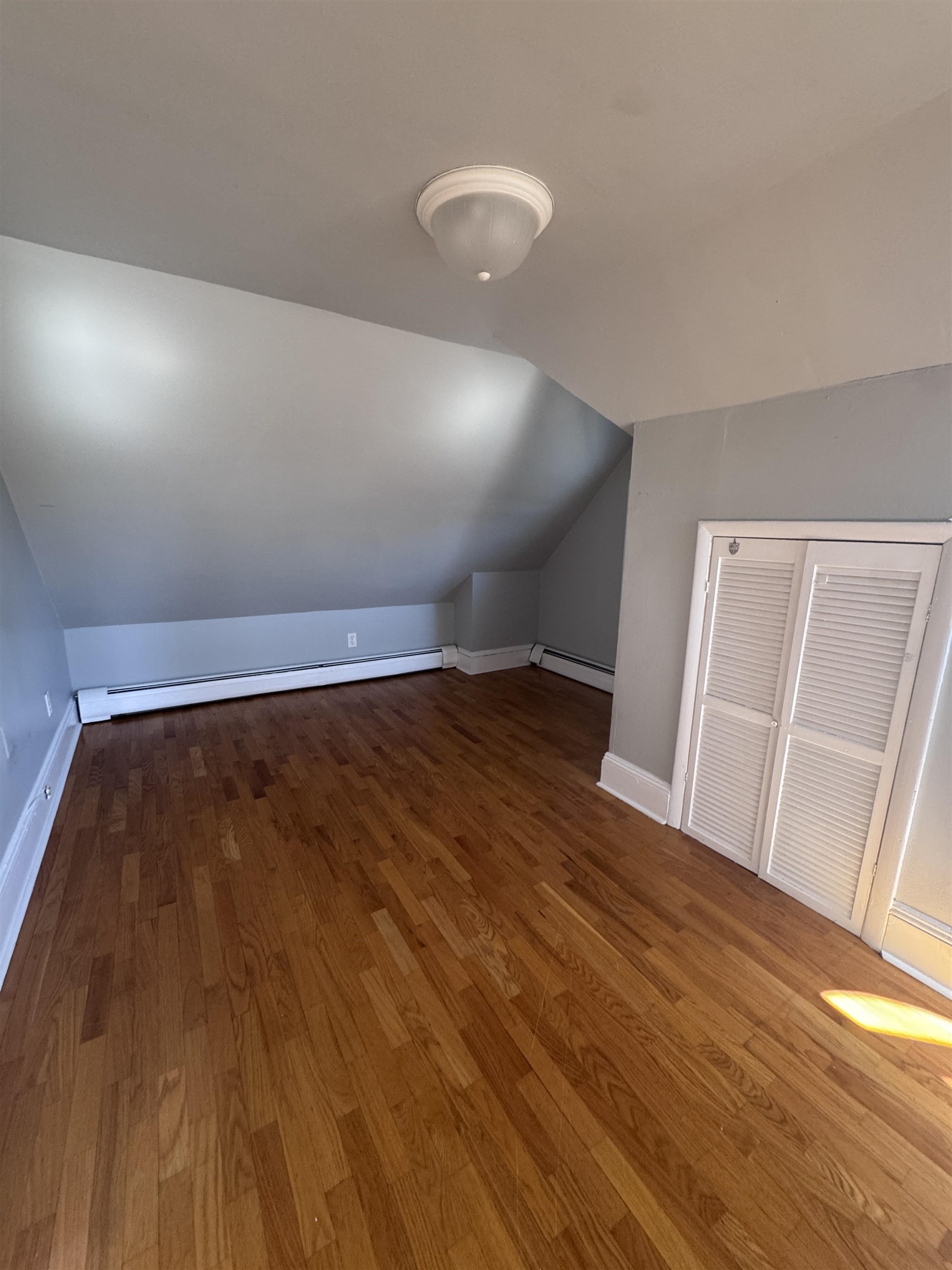 901 Avenue C, Unit 2 Bayonne, NJ 07002 - Photo 1 of 7 a view of empty room with wooden floor