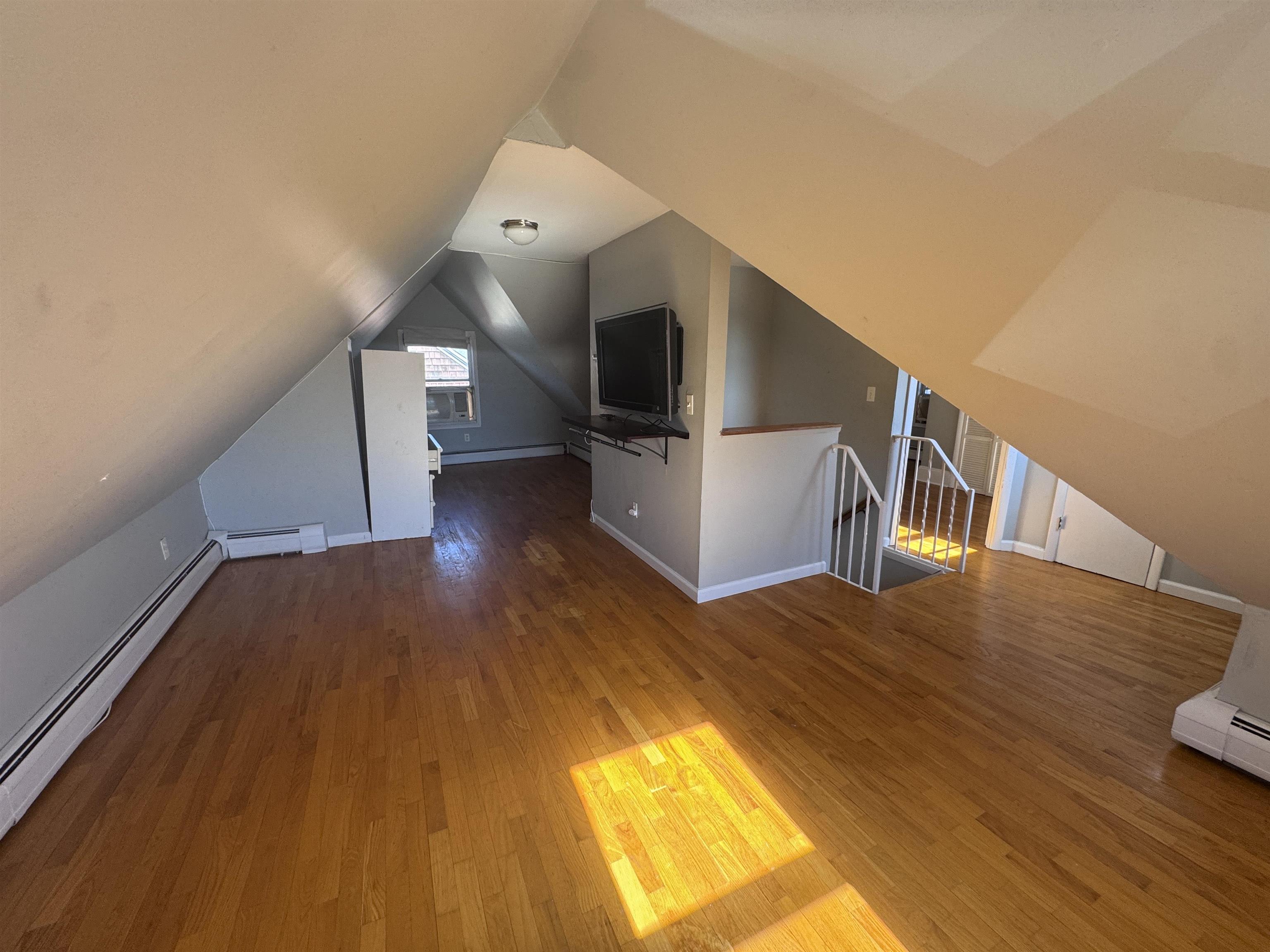 901 Avenue C, Unit 2 Bayonne, NJ 07002 - Photo 2 of 7 a view of entryway and hall with wooden floor