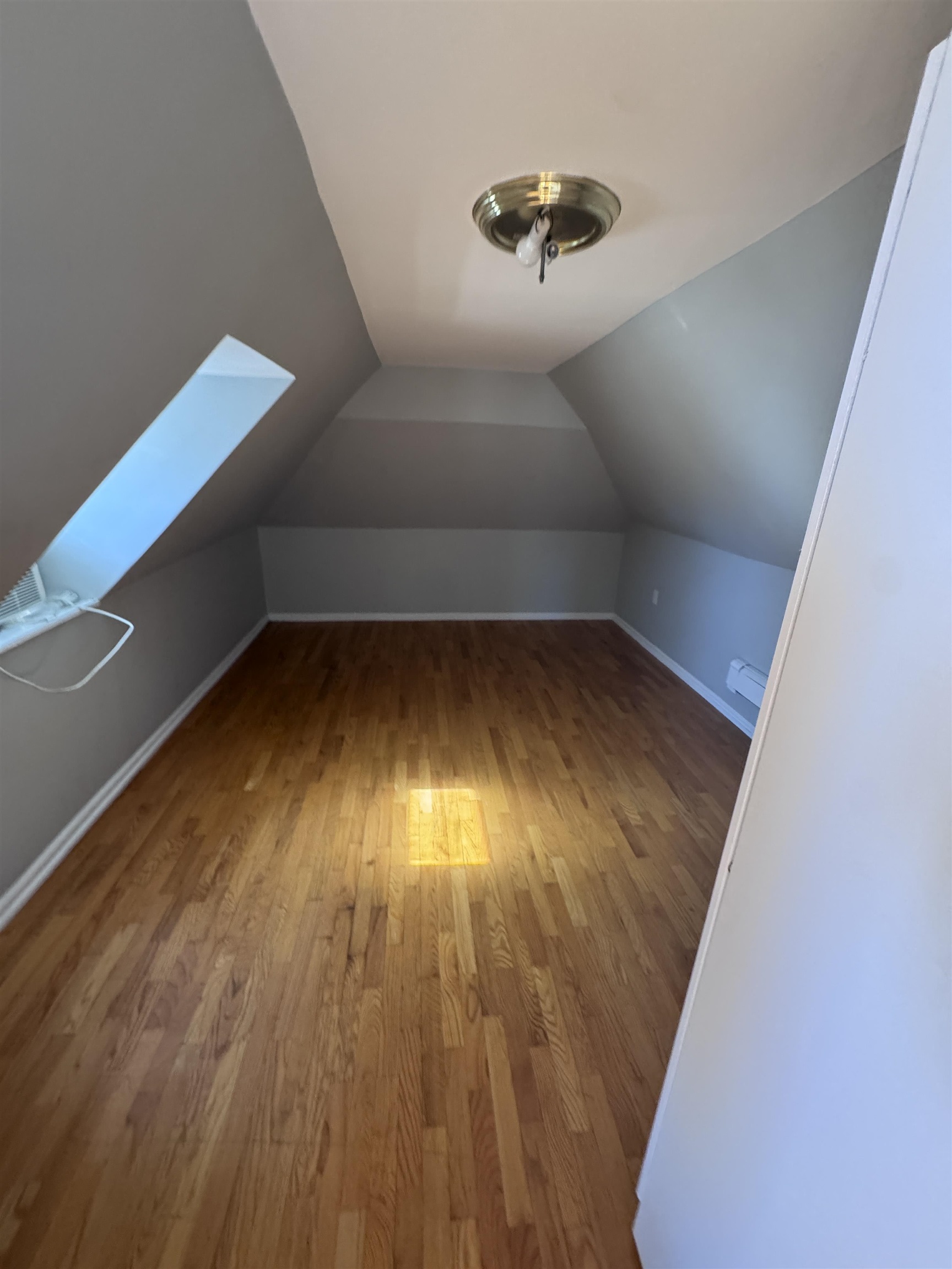 901 Avenue C, Unit 2 Bayonne, NJ 07002 - Photo 3 of 7 a view of an empty room with wooden floor