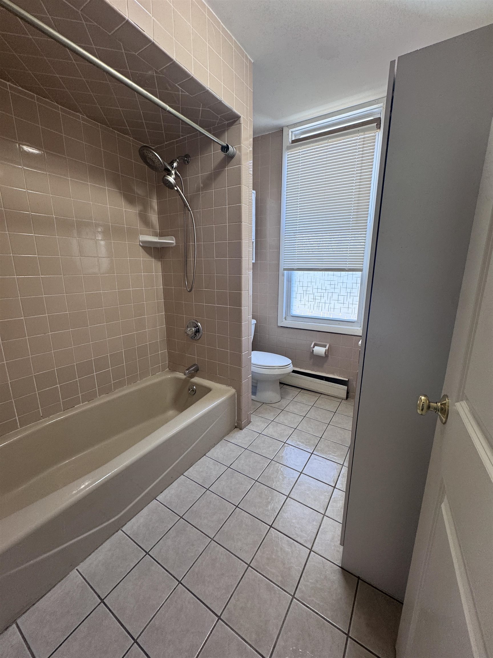 901 Avenue C, Unit 2 Bayonne, NJ 07002 - Photo 4 of 7 a bathroom with a bathtub and a shower