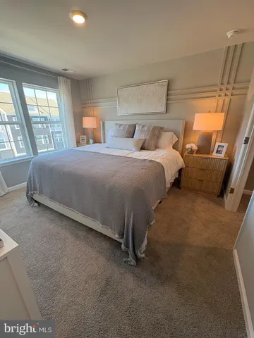 a spacious bedroom with two beds and large windows